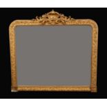 A 19th century giltwood and gesso rounded rectangular over mantel looking glass,