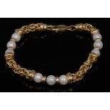 A contemporary fancy link 14ct gold and pearl bracelet,