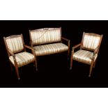 A French Empire mahogany three-piece salon suite, comprising sofa and a pair of armchairs,