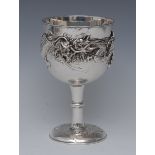 A Japanese silver pedestal goblet, hemi ovoid bowl applied with a a dragon, on a planished ground,