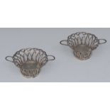 A pair of George III silver wirework bowls, oval bases engraved with a grasped sword,