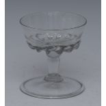 An 18th century glass sweetmeat dish, the bowl with wrythen flutes, folded foot,