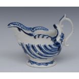 A Derby cream boat, in relief with flutes, the spout with entwined dolphins, scroll handle,