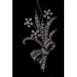 A diamond floral sprays brooch, three flower heads, five arcing leaves, tied with a ribbon bow,
