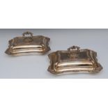 A pair of silver plated shaped rectangular entree dishes, bold gadrooned and shell borders,