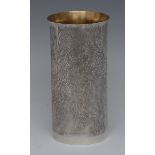 Modern Design - an Elizabeth II cast silver flared cylindrical beaker, bark textured, gilt interior,