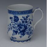 A Bow slightly baluster mug, decorated in underglaze blue with peony and other flowers and foliage,