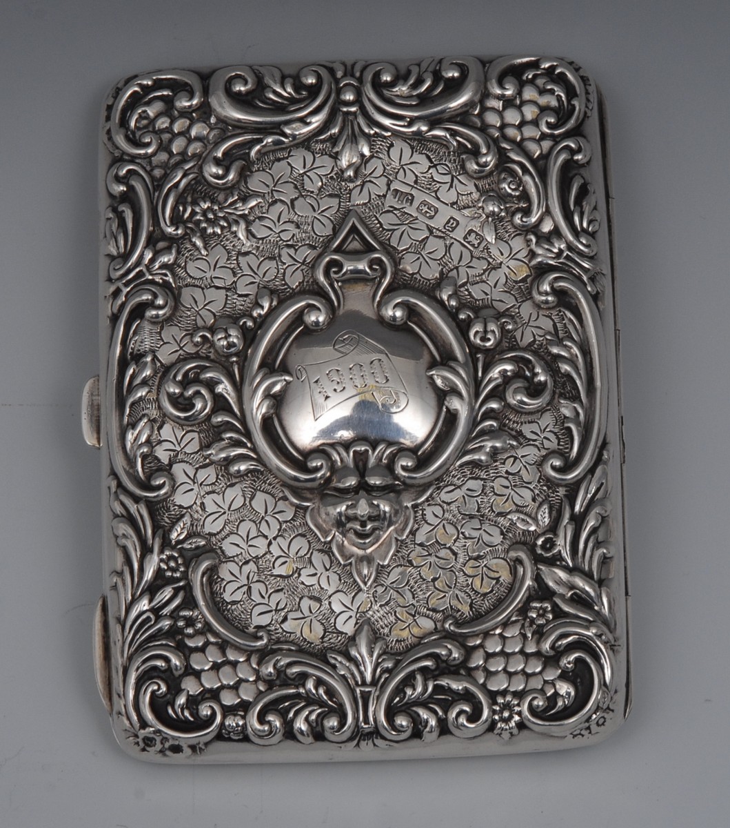 A Victorian rounded rectangular silver card/aide-memoire, embossed with scrolls,