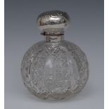 An Edwardian large globular cut glass cologne bottle, with stopper,