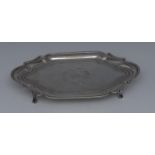 A George III silver commode shaped teapot stand, bright-cut engraved and outlined with wrigglework,