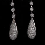 A pair of diamond pave encrusted torpedo drop earrings,