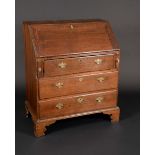 A George III oak bureau, the fall front enclosing a fitted interior of drawers and pigeon holes,