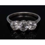 A diamond trilogy ring, central round brilliant cut diamond approx 0.