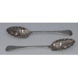 A pair of silver Old English pattern berry spoons, engraved and chased with scrolling foliage,