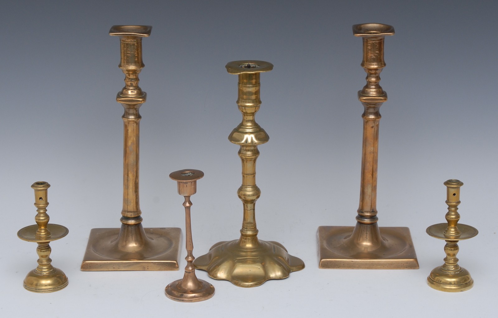 A pair of 18th century brass candlesticks, knopped stems, dished square bases, 26cm high, c.