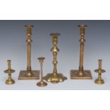 A pair of 18th century brass candlesticks, knopped stems, dished square bases, 26cm high, c.
