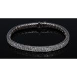 A diamond tennis bracelet/bangle, inset with two continuous rows of square princess cut diamonds,