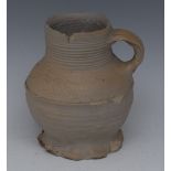 An English 17th century white saltglazed ribbed stoneware tavern mug, loop handle, crimped foot,