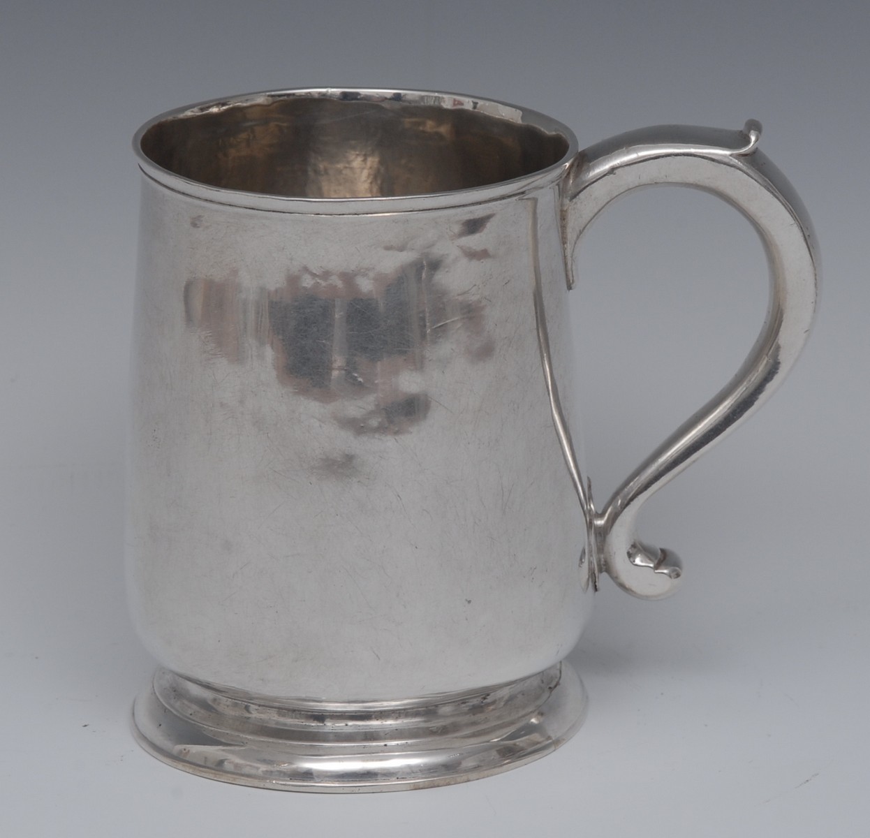 A George II silver mug, scroll-capped handle, skirted base, 11cm high,