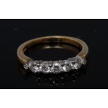 A seven stone diamond ring, central band of five round brilliant cut diamonds,