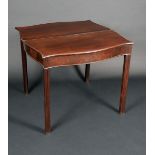 A George III mahogany serpentine tea table, folding top above a deep frieze, moulded legs,
