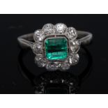 An emerald and diamond cluster ring, central square cushion cut emerald, approx 1.