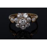 A diamond daisy head cluster ring, central round brilliant cut diamond, approx 0.