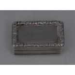 A George IV silver rounded rectangular vinaigrette, hinged cover centred by a vacant cartouche,