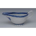 A Bow sauce boat, moulded in relief with flowerhead and foliage with a cartouche,