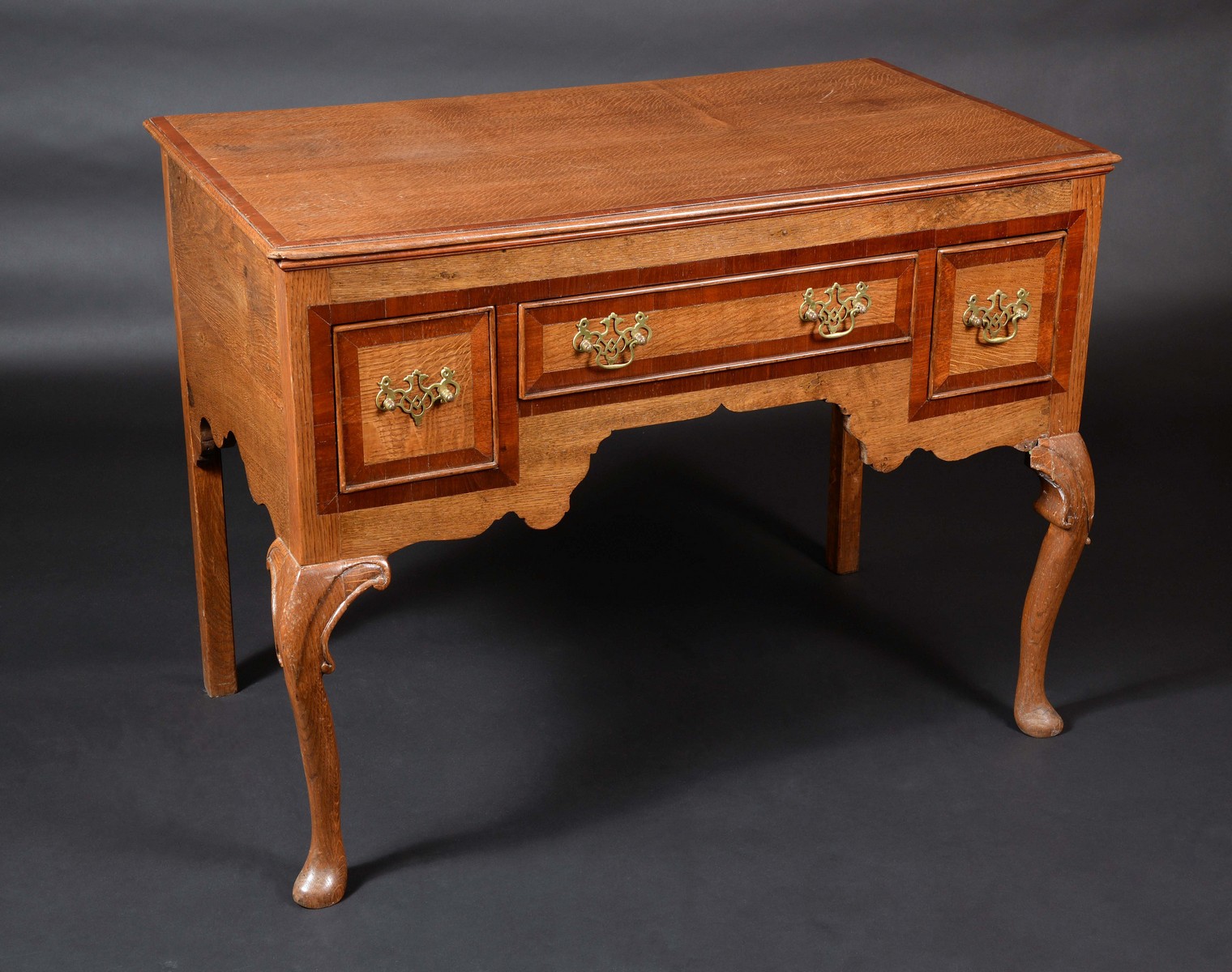 A 'George III' mahogany crossbanded oak lowboy, moulded top above three drawers,