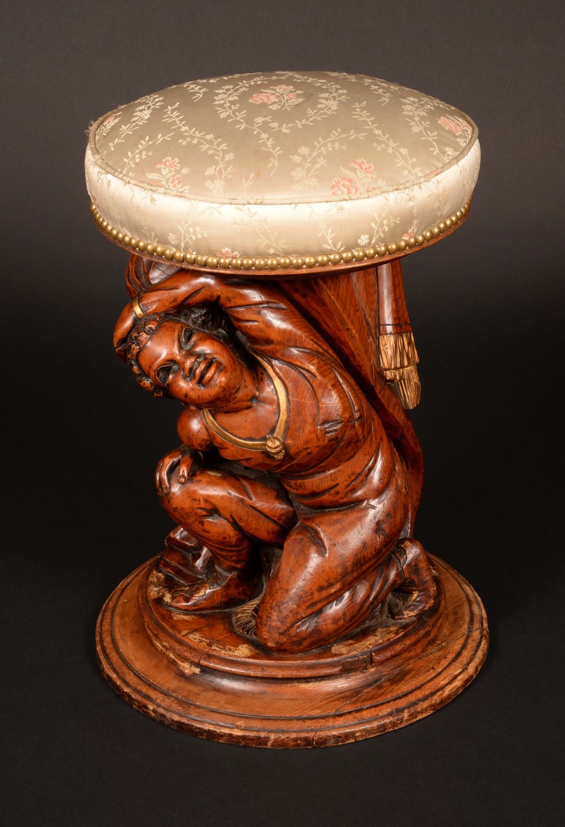 A 19th century Venetian carved and parcel gilt figural stool, as a kneeling Nubian attendant,