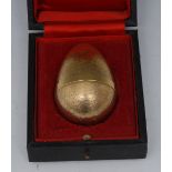 Stuart Devlin - an Elizabeth II silver-gilt surprise egg, textured overall, enclosing a rabbit, No.