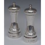 A pair of Elizabeth II tall silver salt and pepper mills, of typical form, 16cm high,