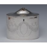 A George III Neo-Classical silver oval tea caddy, flush-hinged domed cover with flower finial,