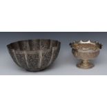 An Indian silver coloured metal pedestal bowl, wavy everted rim,