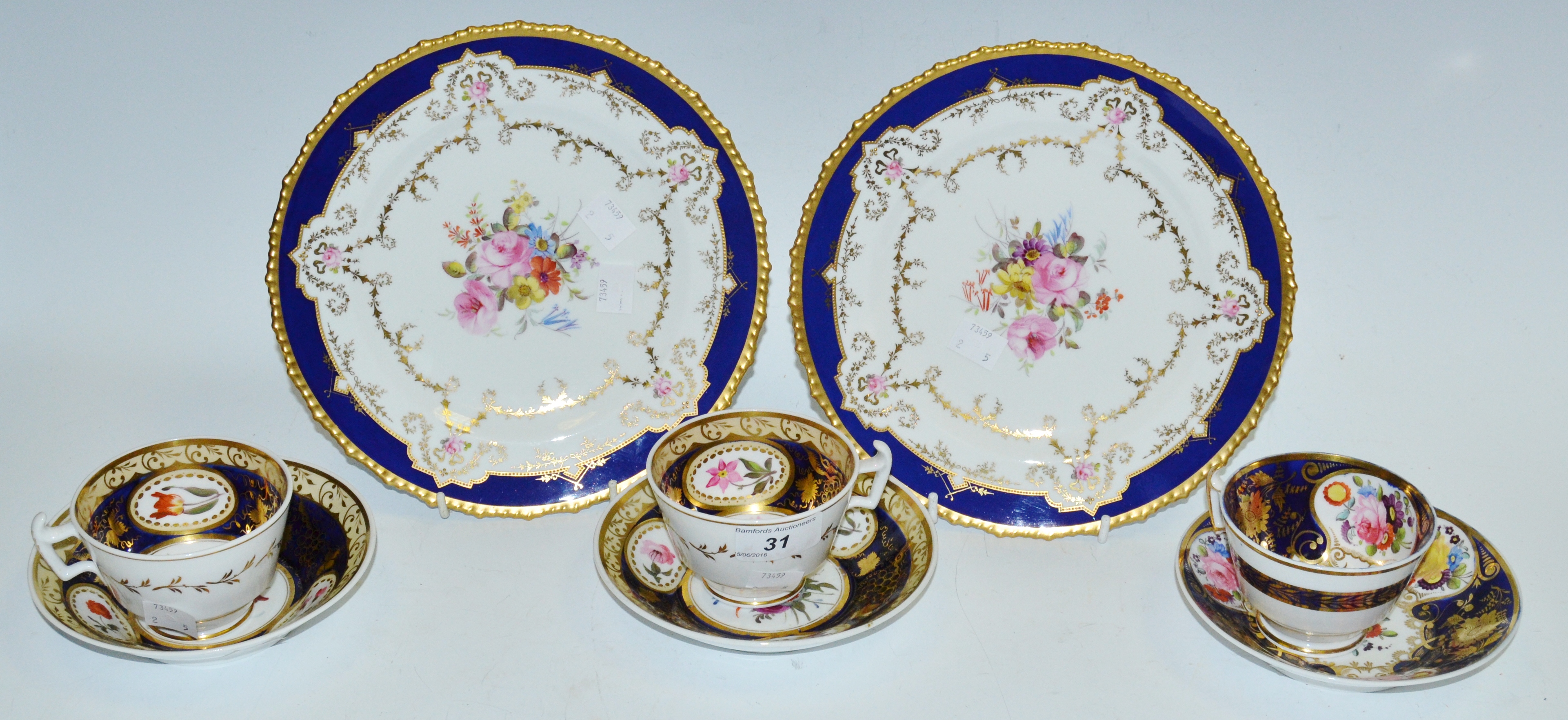 A pair of Coalport cups and saucers c1820, London shape blue ground,