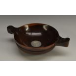 A 19th century Scottish lignum vitae quaich, applied with a silver-coloured metal roundel,