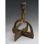 A 19th century iron socket candlestick, cruciform base,