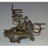 A 19th century dark patinated bronze novelty chamber stick, cast as a devil holding a coiled snake,