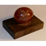 A 19th century Derbyshire spar egg shaped desk weight, rectangular marble base,