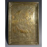 A 19th century Indian brass rectangular icon, chased and engraved with a deity,