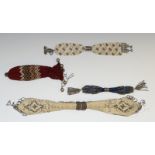 A 19th century beadwork miser's purse, decorated with lozenges of cut steel pinwork, 38.5cm long, c.