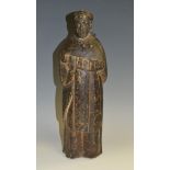 A 19th century Indo-Portuguese carving of a saint, he stands wearing a long habit,