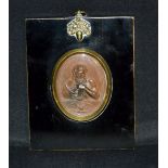 A 19th century brown patinated oval medallion, in low relief with Vulcan and his attributes,