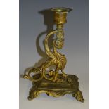 A 19th century gilt metal chamber stick, cast as a sphinx, hexagonal sconce,
