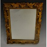 A 19th century giltwood rectangular looking-glass, carved with a border of shells and leafy scrolls,