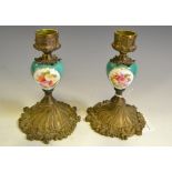 A pair of French gilt metal and porcelain boudoir candlesticks,