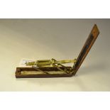 A George III brass folding guinea scale, mahogany case,