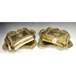 A pair of silver plated shaped rectangular entree dishes, bold gadrooned and shell borders,