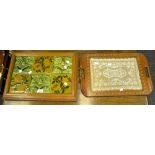 An early to mid 20th Century oak tray inlaid with tiles; another,